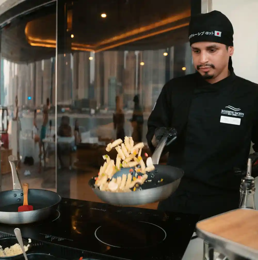 A chef cooking at a live station in the galley