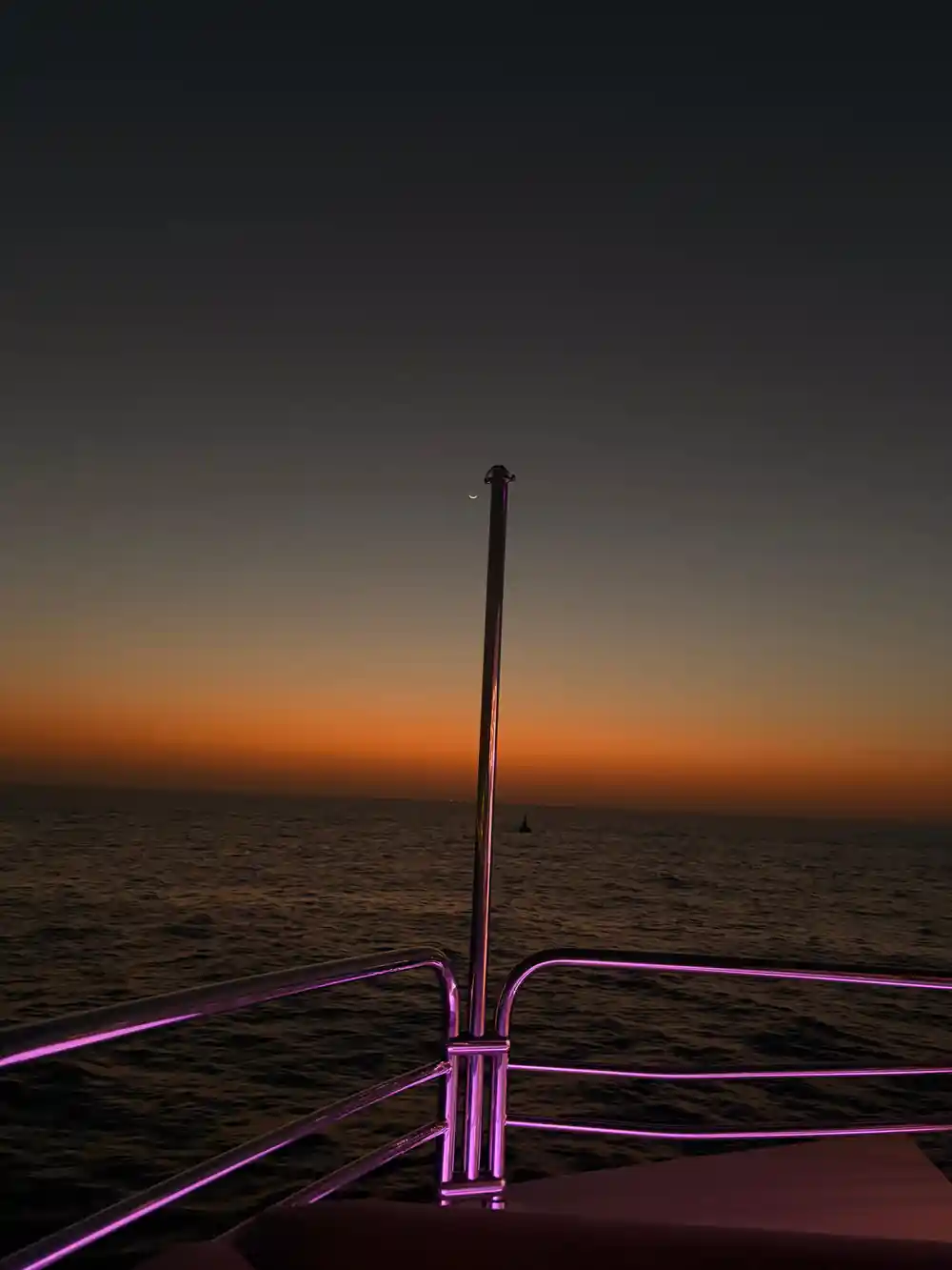 Dusk over the Gulf seen past the yacht's rigging