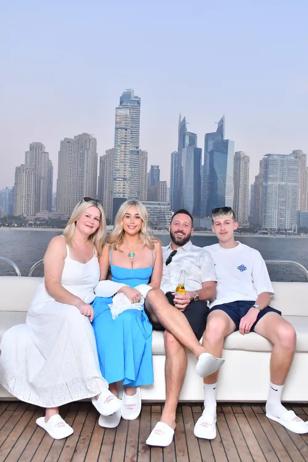 A family group posing on deck with the Marina behind