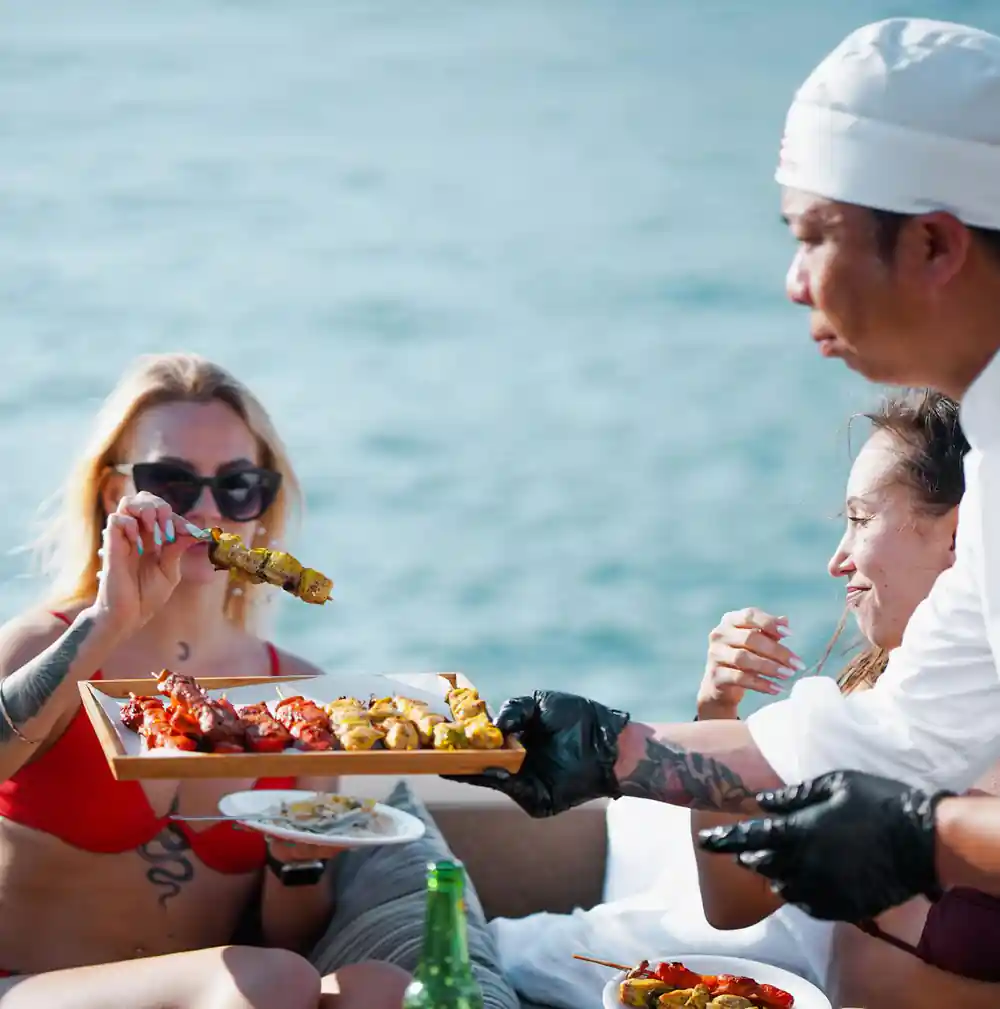 Guests eating from a seafood platter on the sun deck
