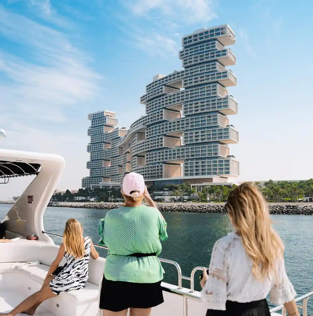 Guests at the rail looking at the stepped Royal Atlantis tower