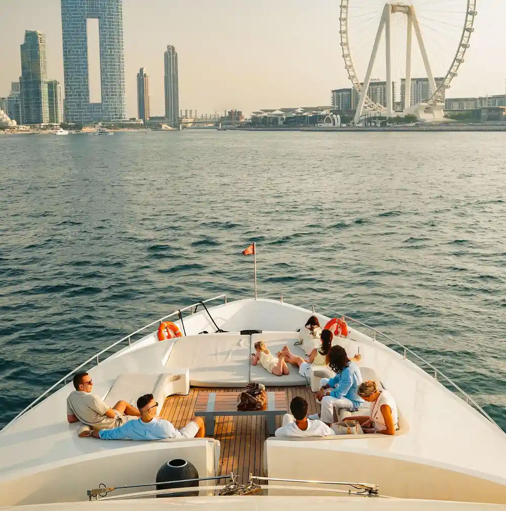 Guests spread across the bow seating with the skyline beyond