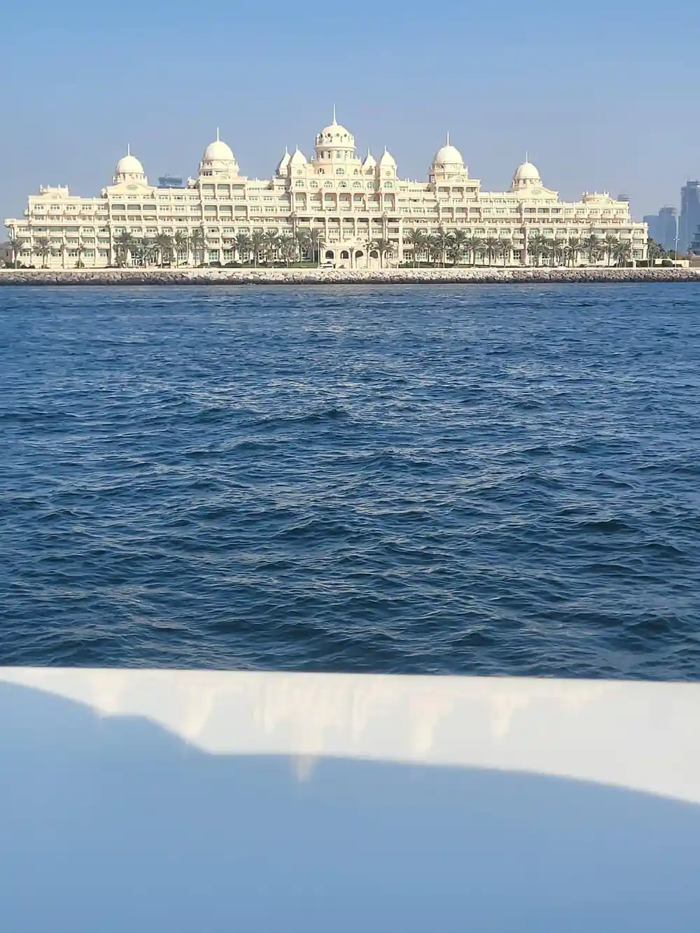 An ornate palm-shaped resort building seen from the water