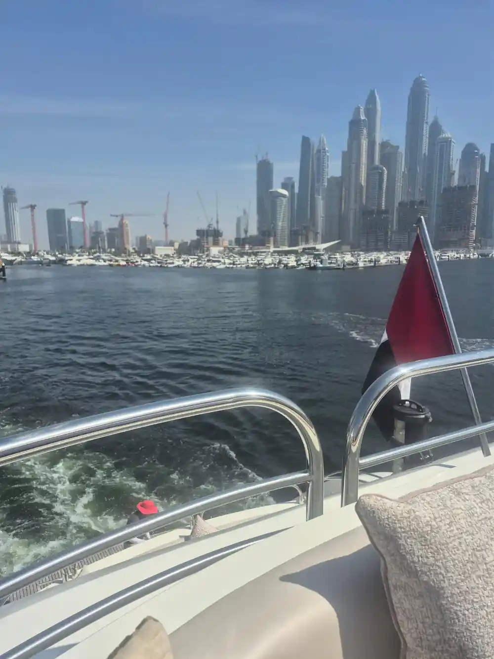The wake and the UAE flag with the skyline behind
