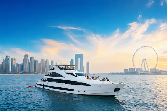 The white superyacht under way with the Dubai skyline behind