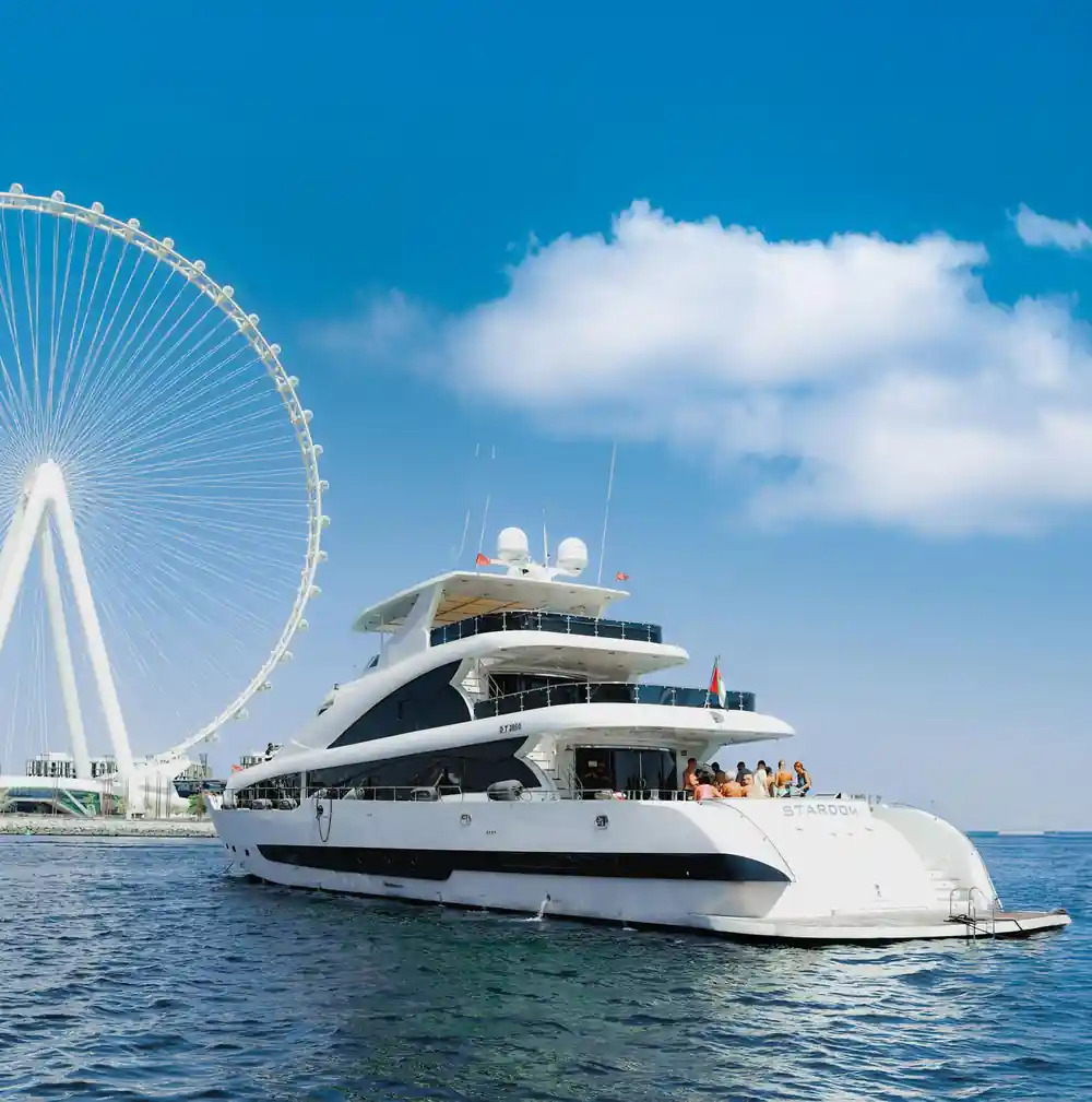 The yacht at anchor beside the Ain Dubai observation wheel
