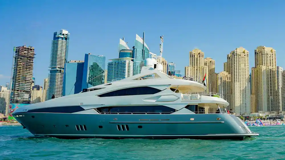 The yacht's flybridge and mast against the Marina towers