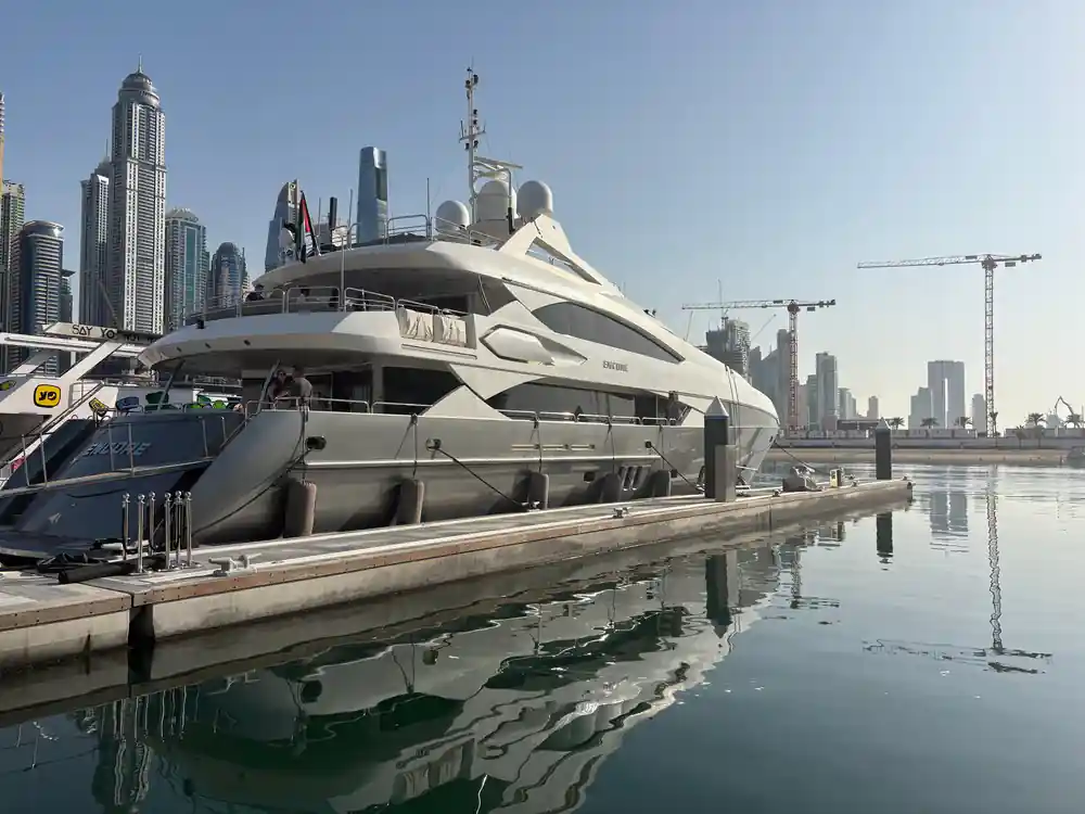 The yacht moored at the quay with towers behind